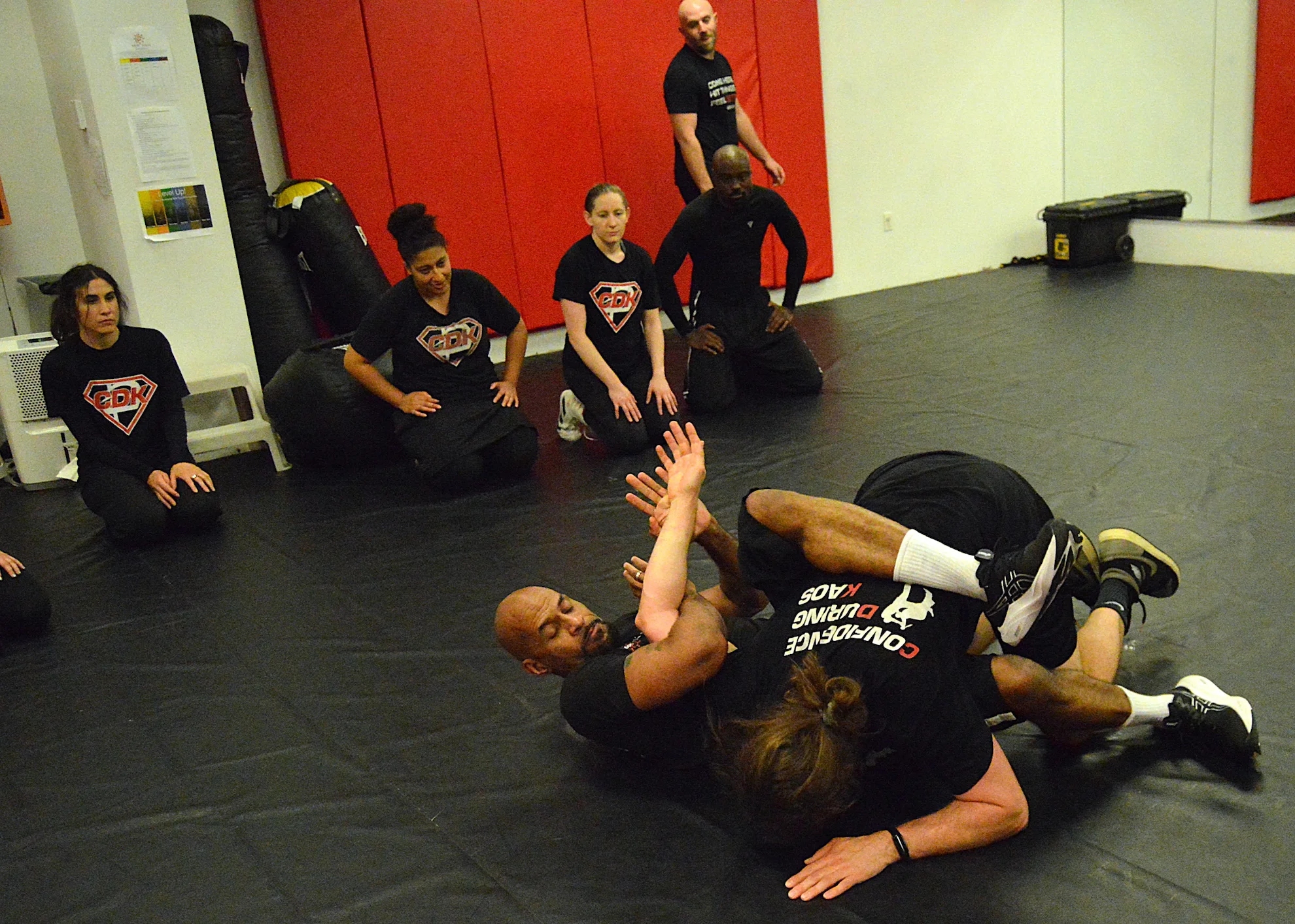 Instructor demonstrating a ground-fighting escape technique during a self-defense class in Bethesda, Maryland.