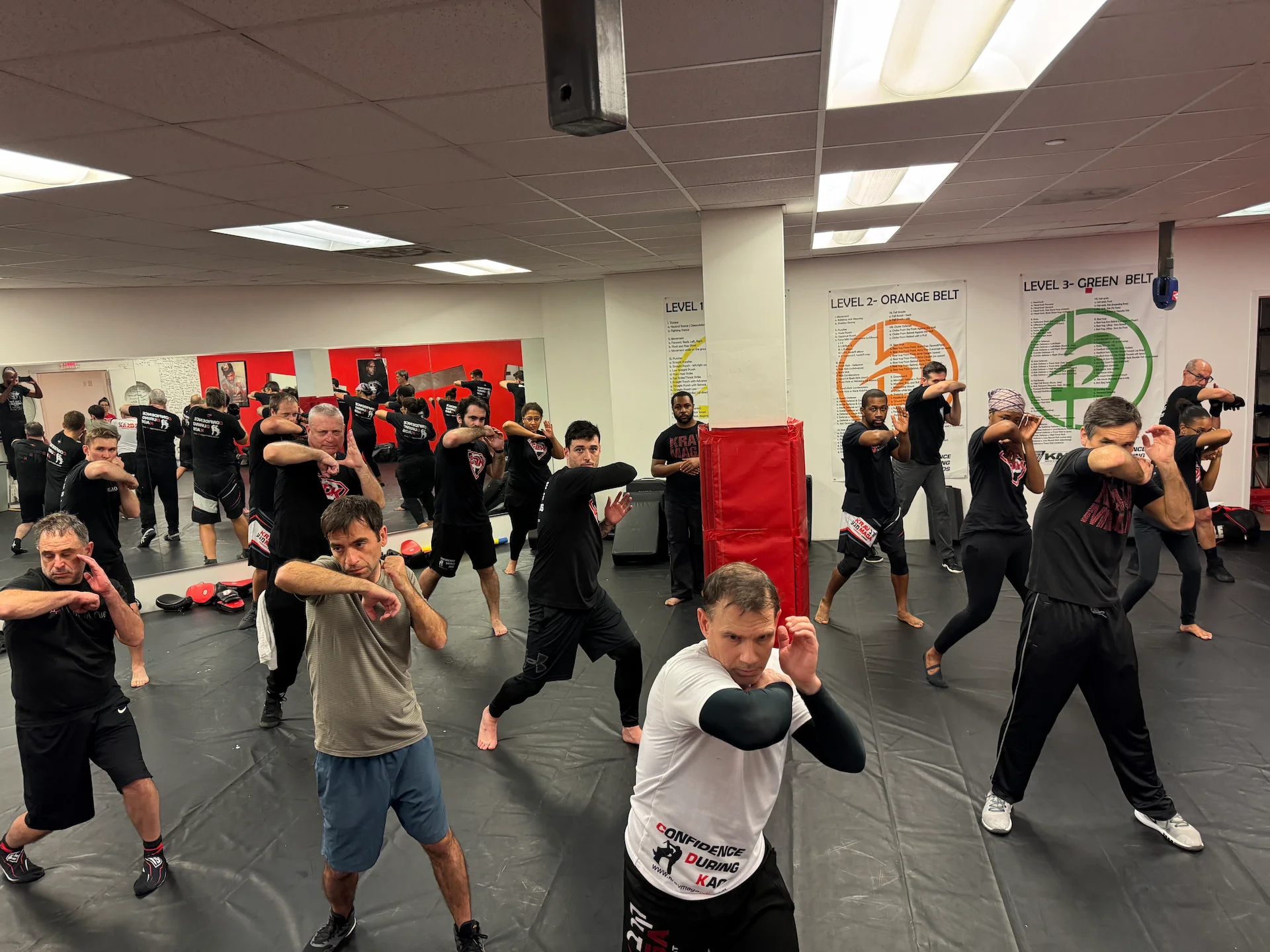 Adults practicing defensive elbow techniques during a Krav Maga class at CDK in Bethesda, Maryland.