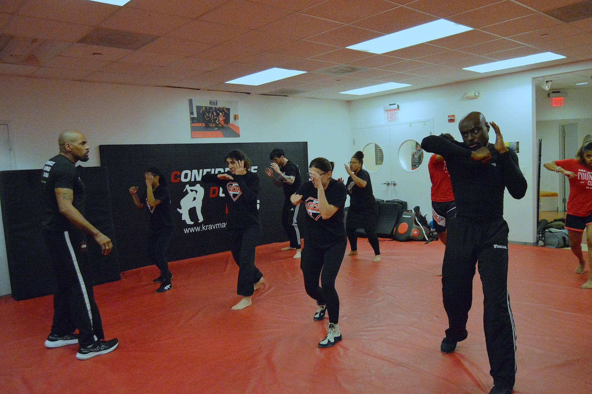 Adults practicing defensive elbow techniques during a group Krav Maga class in Bethesda, Maryland.