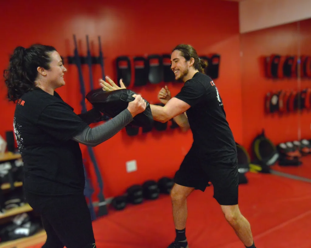 Woman practicing a close-range self-defense technique with an instructor during private Krav Maga training in Bethesda, Maryland