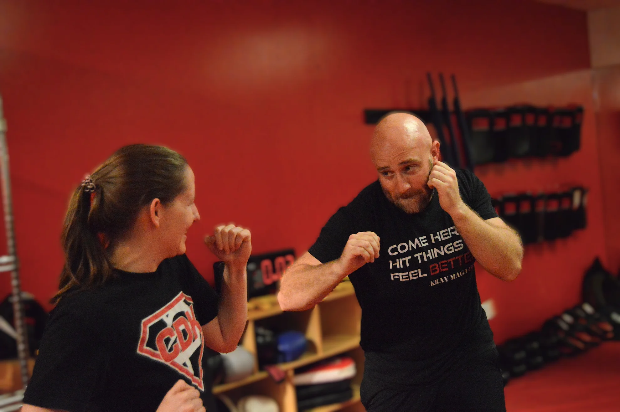 Instructor and student practicing one-on-one self-defense techniques during a private Krav Maga and fitness session in Bethesda, Maryland.