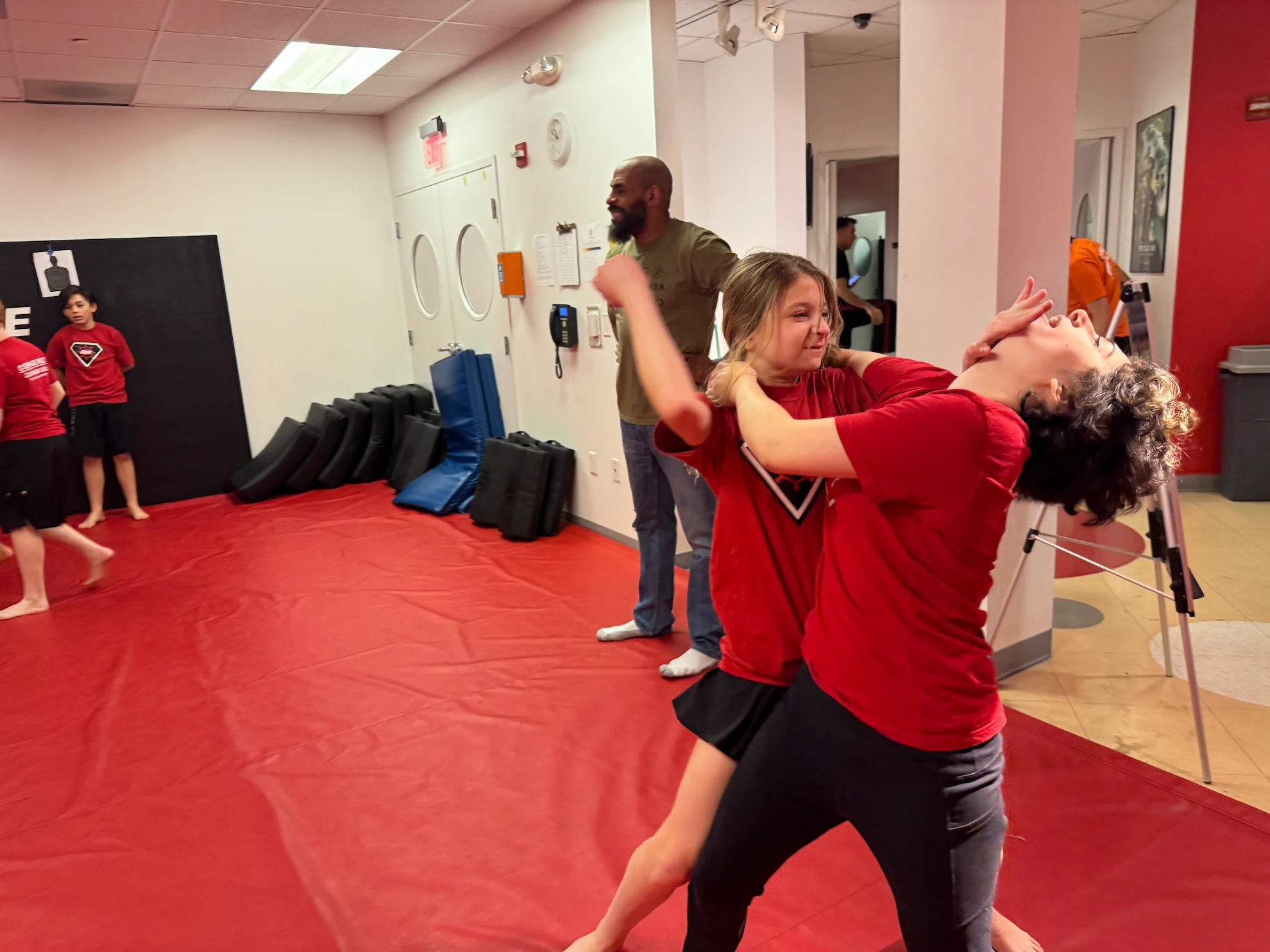 Teen students practicing an escape from a grab during a self-defense class in Bethesda, Maryland.